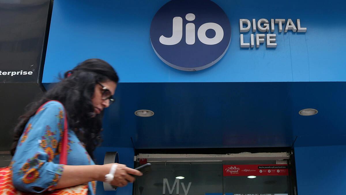 Một người phụ nữ đi ngang qua cửa hàng di động Jio Digital Life thuộc Tập đoàn Reliance Industries ở Mumbai (Ấn Độ). Ảnh: Reuters.